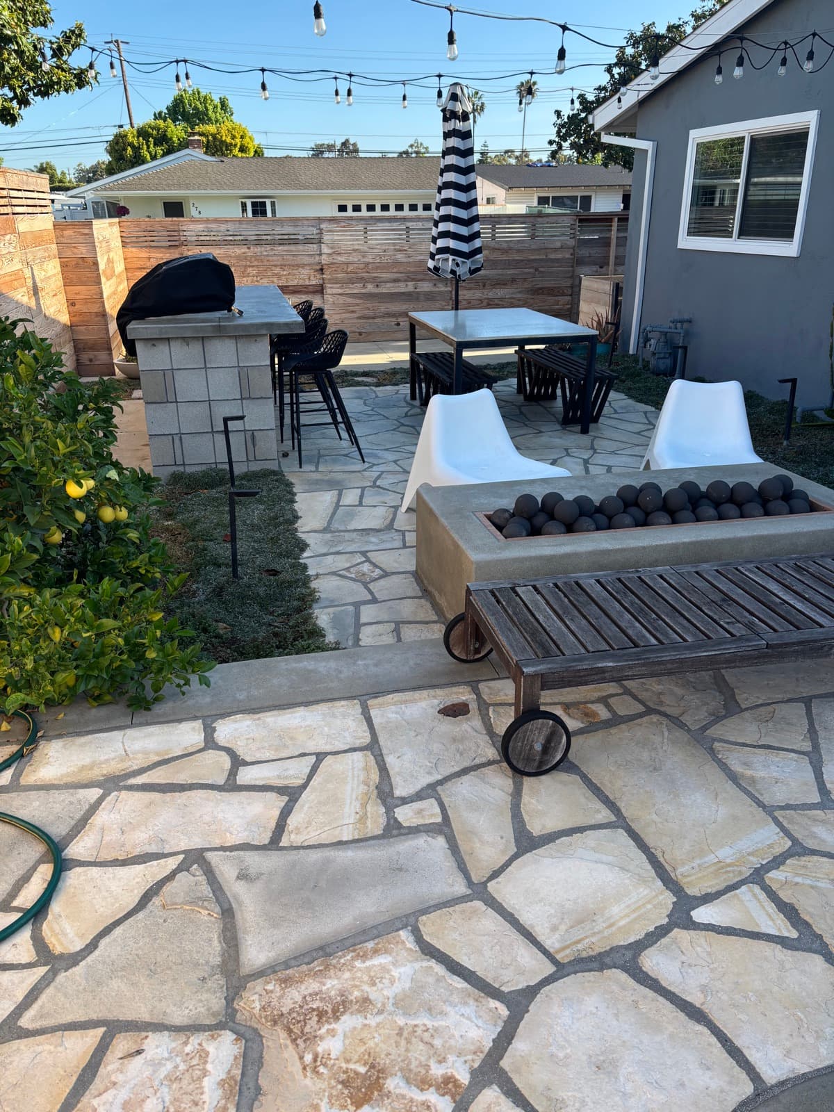 Finished flagstone patio and outdoor living space built by Legendary Landscaping in Orange County